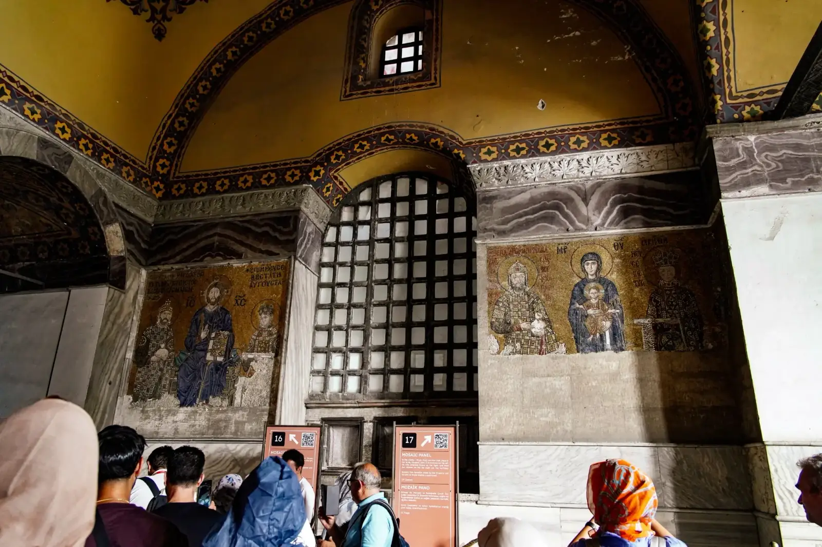 Byzantine mosaics seen from the upper gallery, gold ground catching the light.